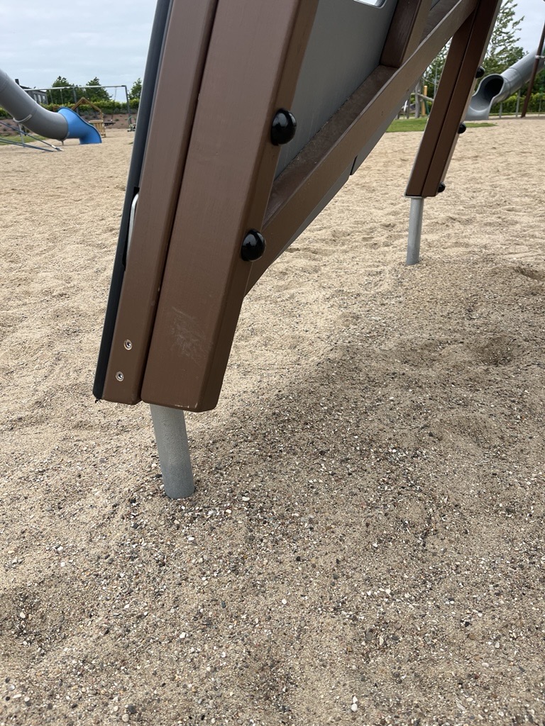 steel footings on wooden playground tower