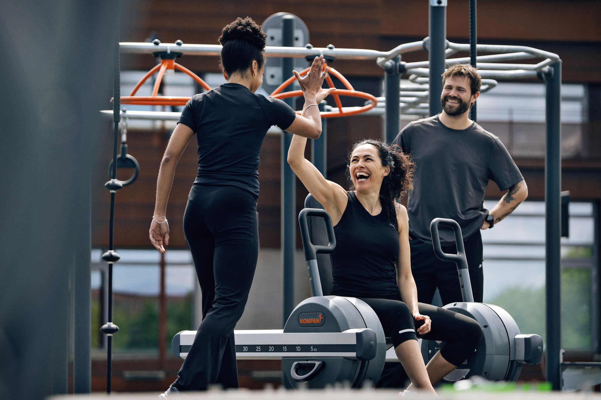 woman working out on outdoor gym equipment