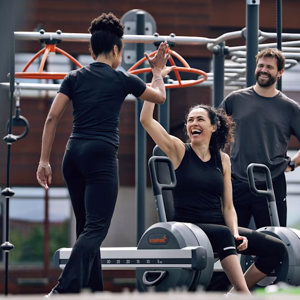 woman working out on outdoor gym equipment