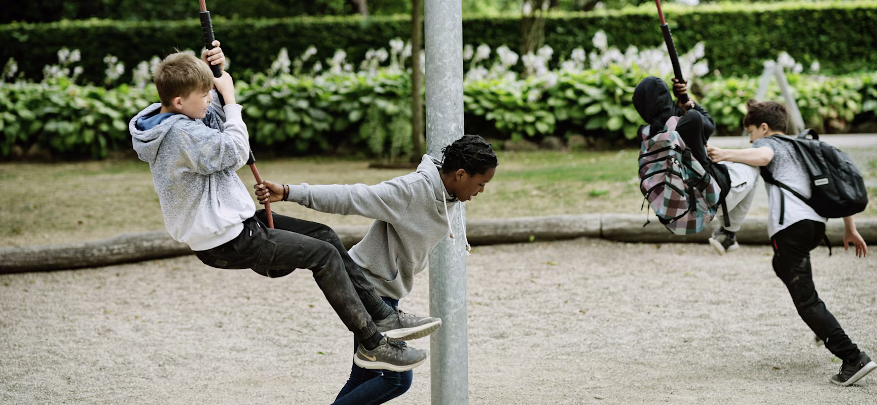 Tweens playing on rotating playground equipment
