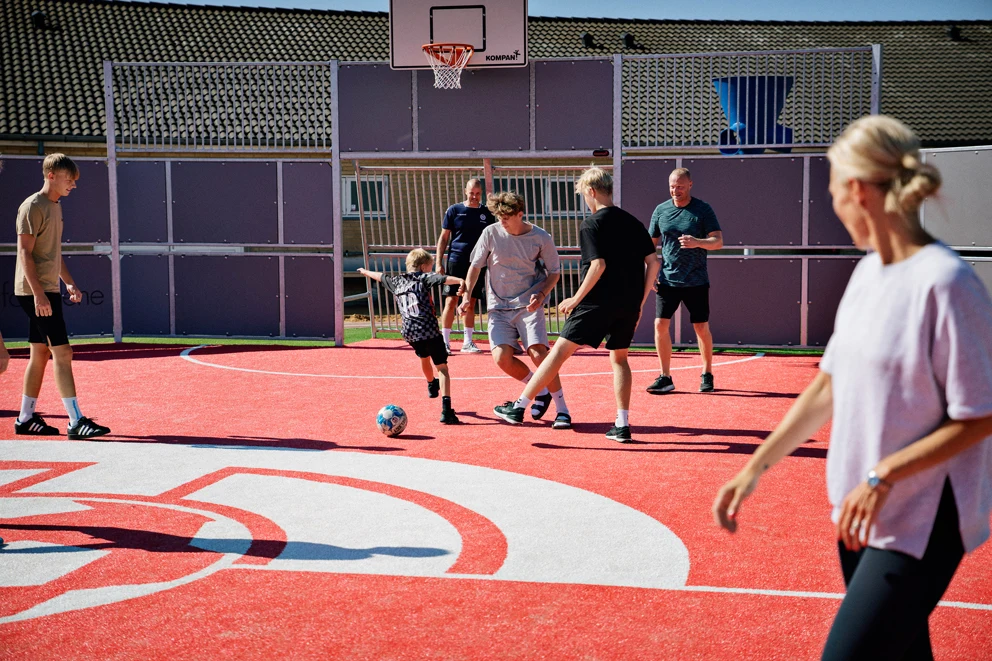Community picture from Denmark, people playing soccer on a multi court