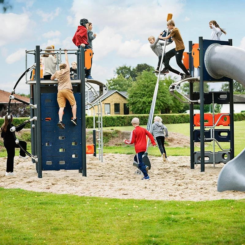 School agers playing in schoolyard on challenging play system