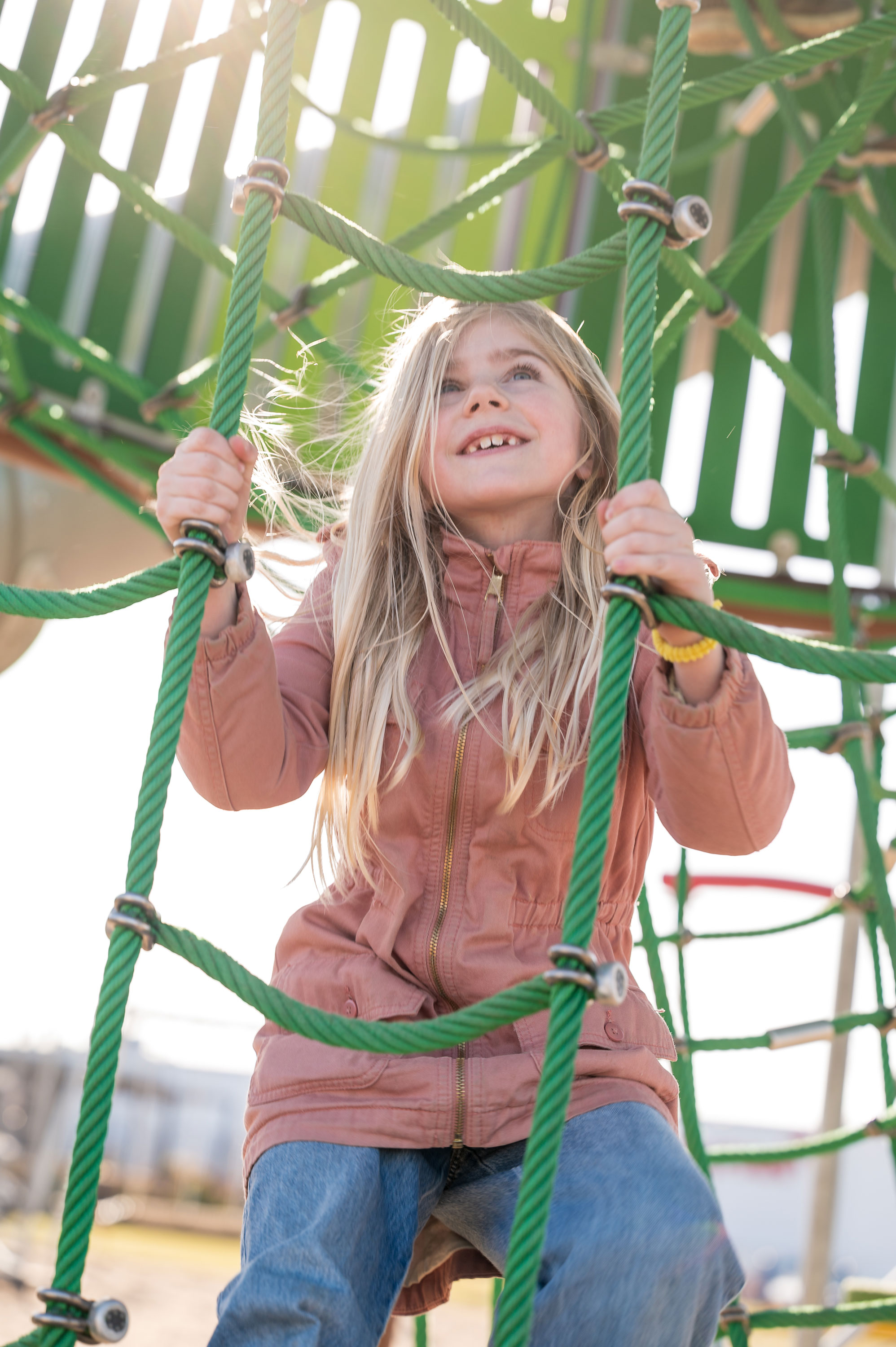 girl climbing in a custom net tower