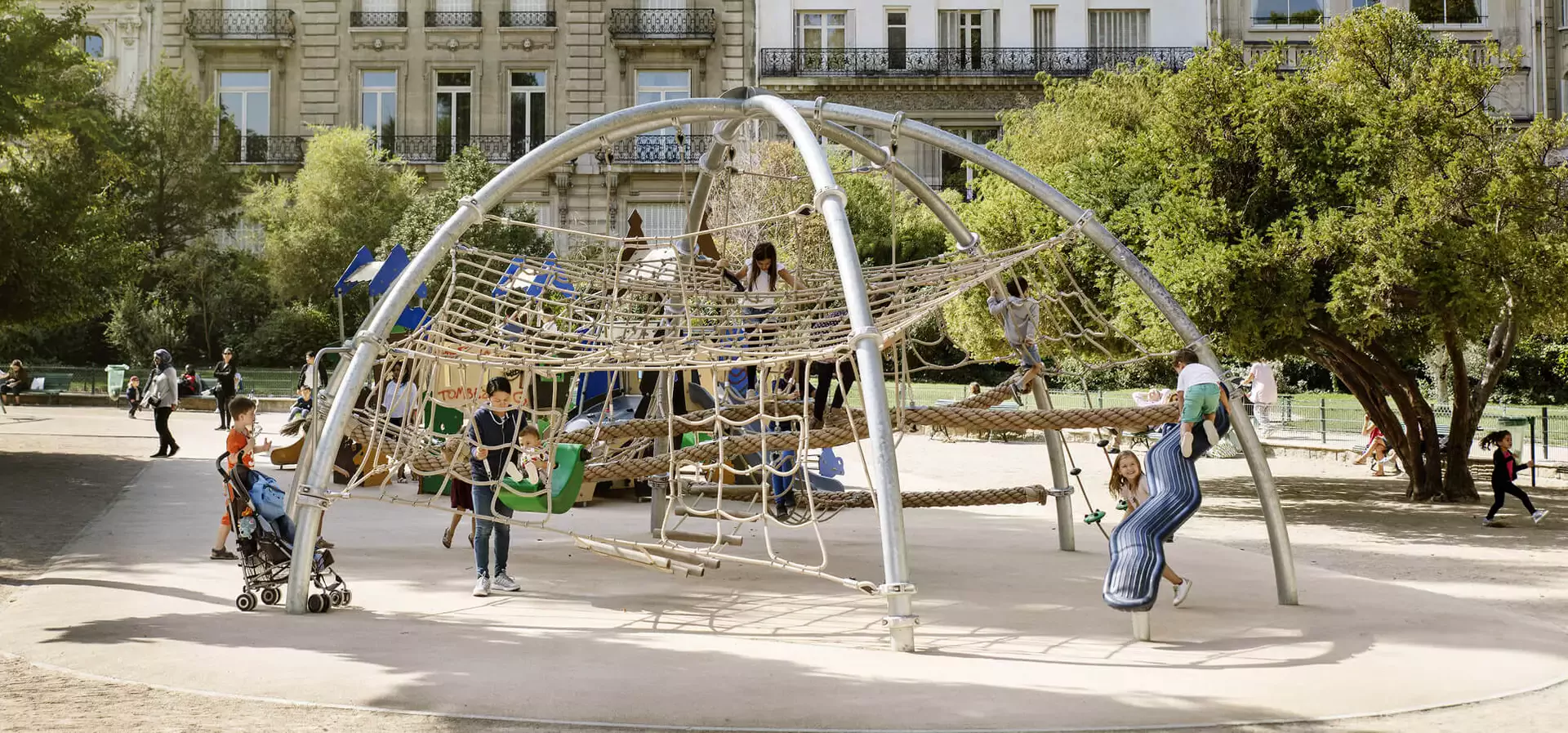 children playing on a corocord rope playground climbing domes arches and spheres hero image