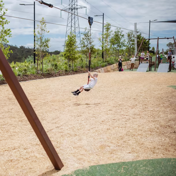 Kids flying on a KOMPAN double playground Flying Fox