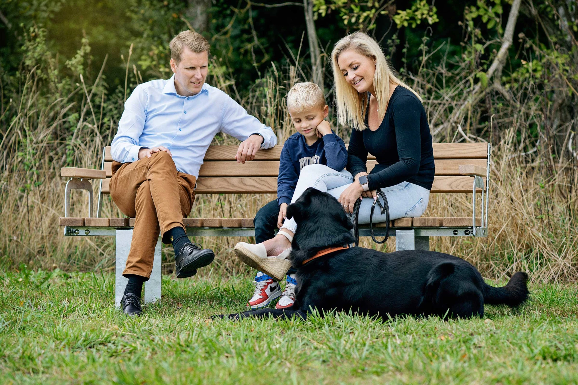 Family sitting on a bench on a playground