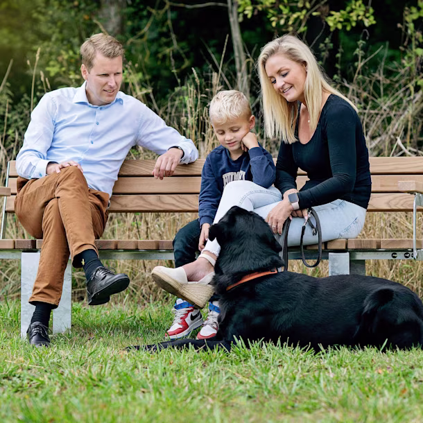 Family sitting on a bench on a playground