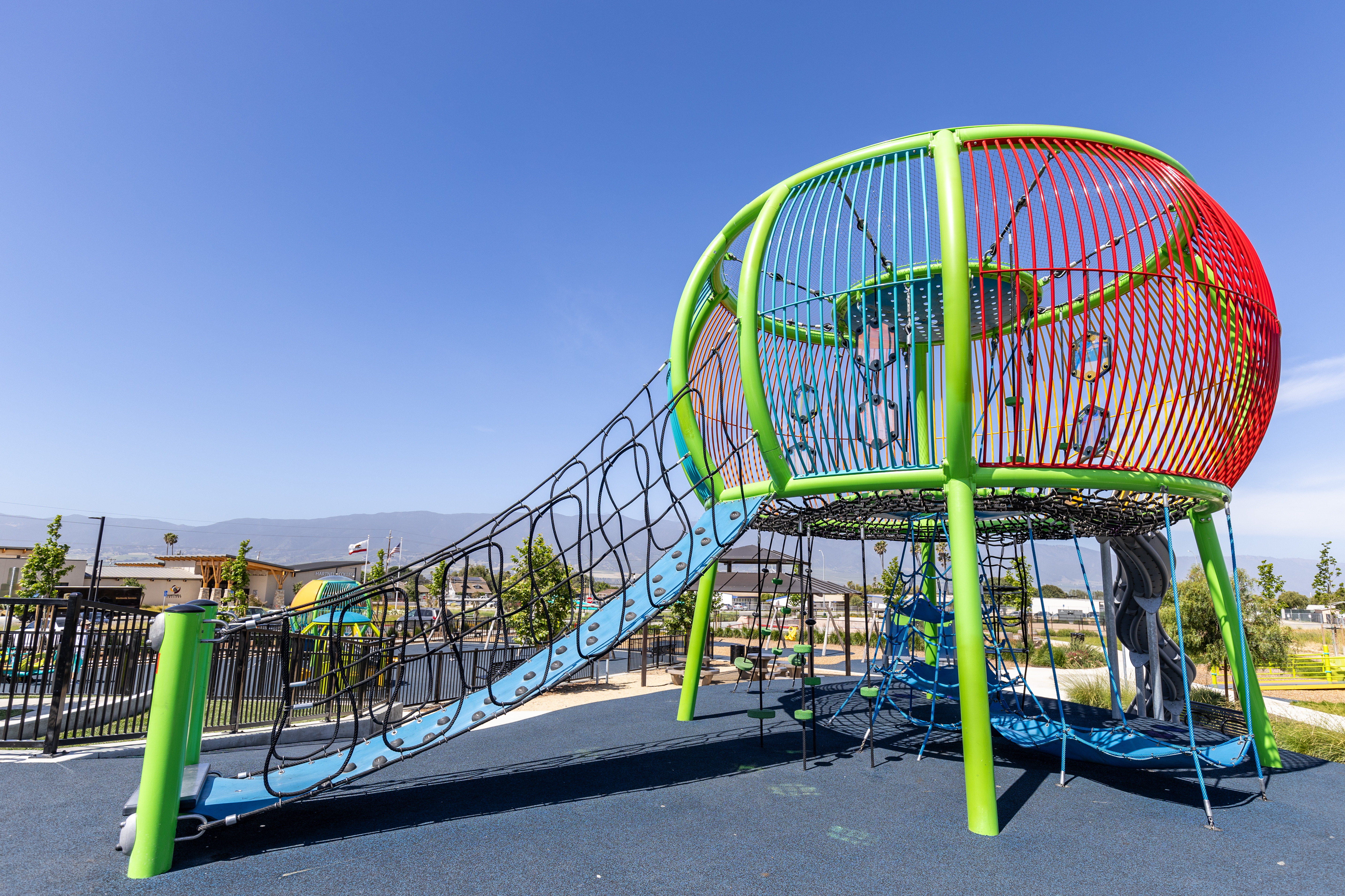 Colorful custom rope climbing structure at Orchard Lane Park in Soledad, California