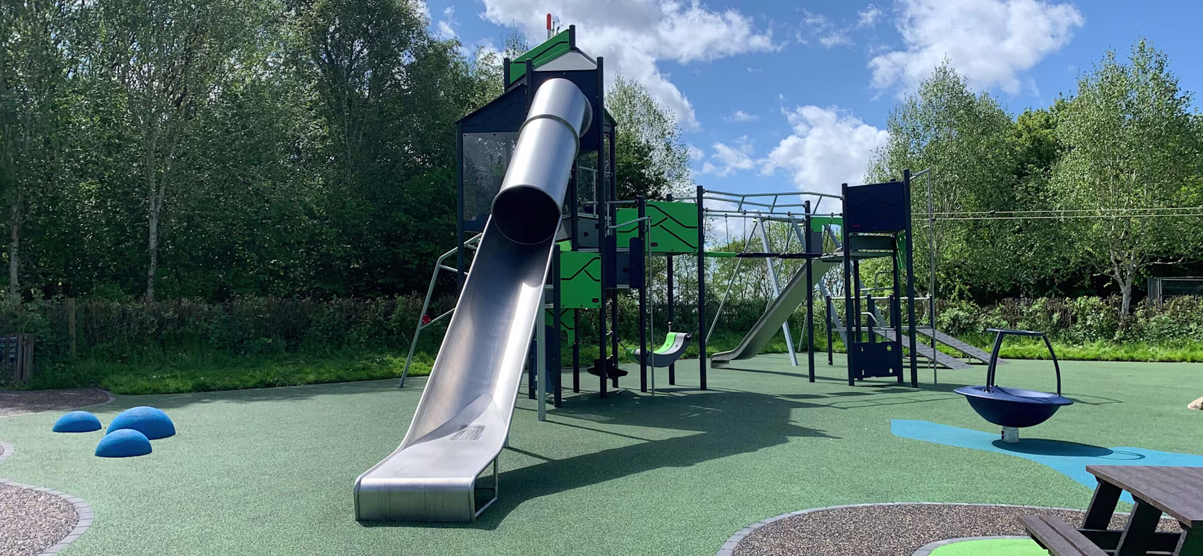 playtower with net bridge and slide in a park