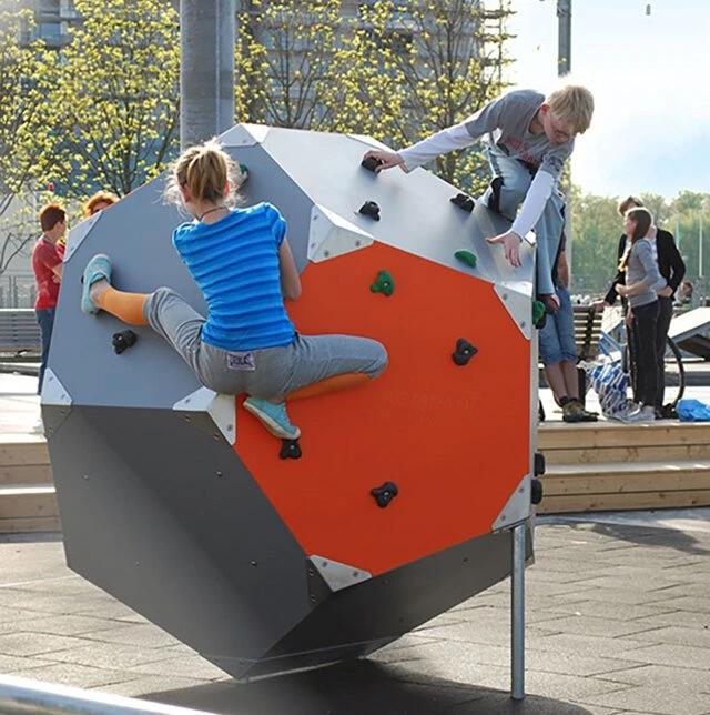 Teens climbing on climbing bloqx in an urban area 