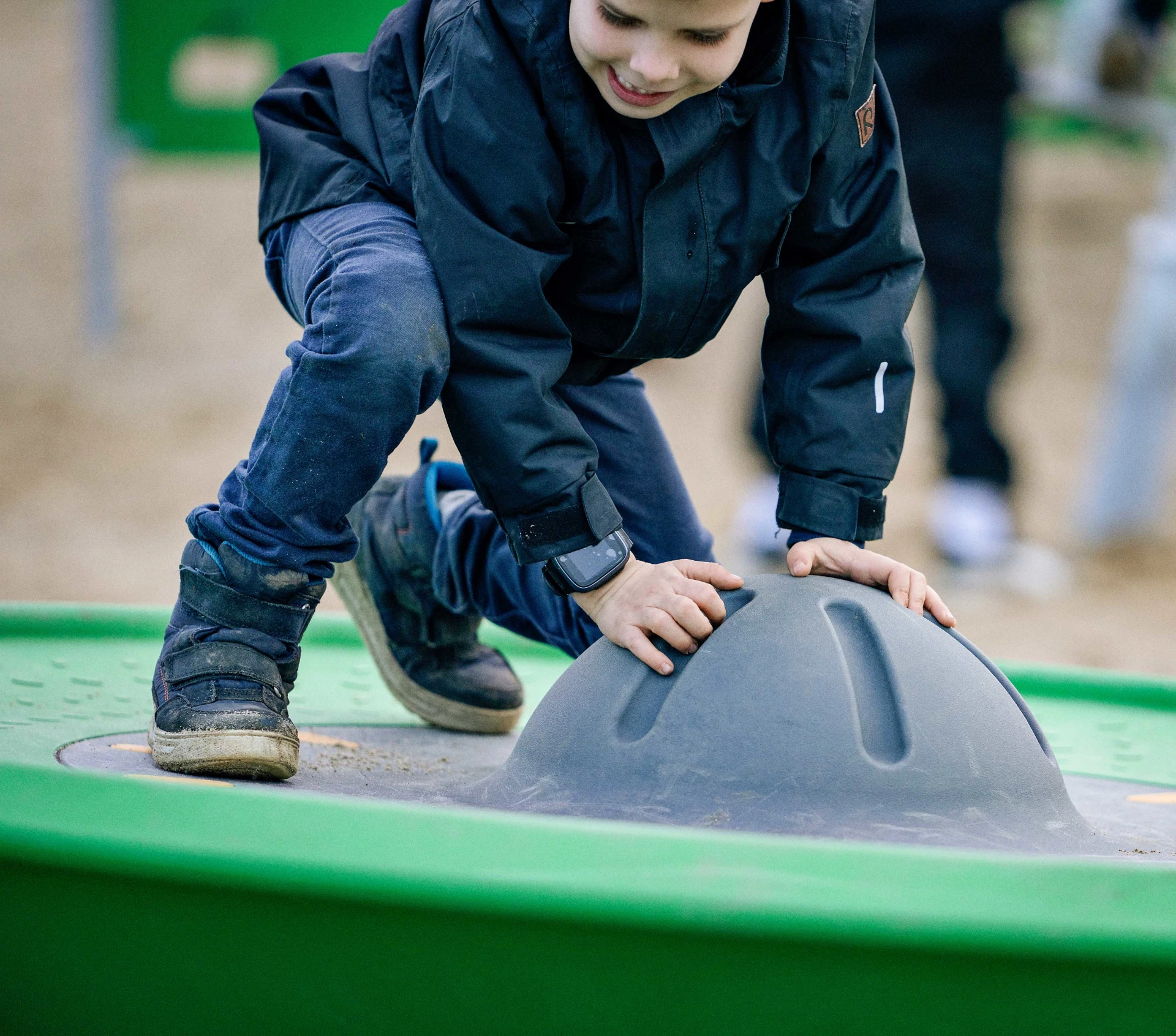 A child holding onto the center piece of the Spinner Disc