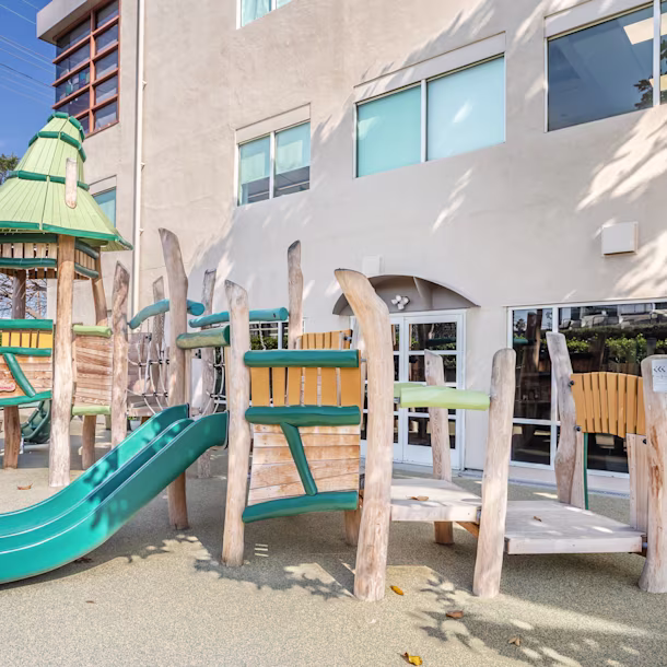 Whimsical wooden play structure at Mann Family Early Childhood Center in Los Angeles, California