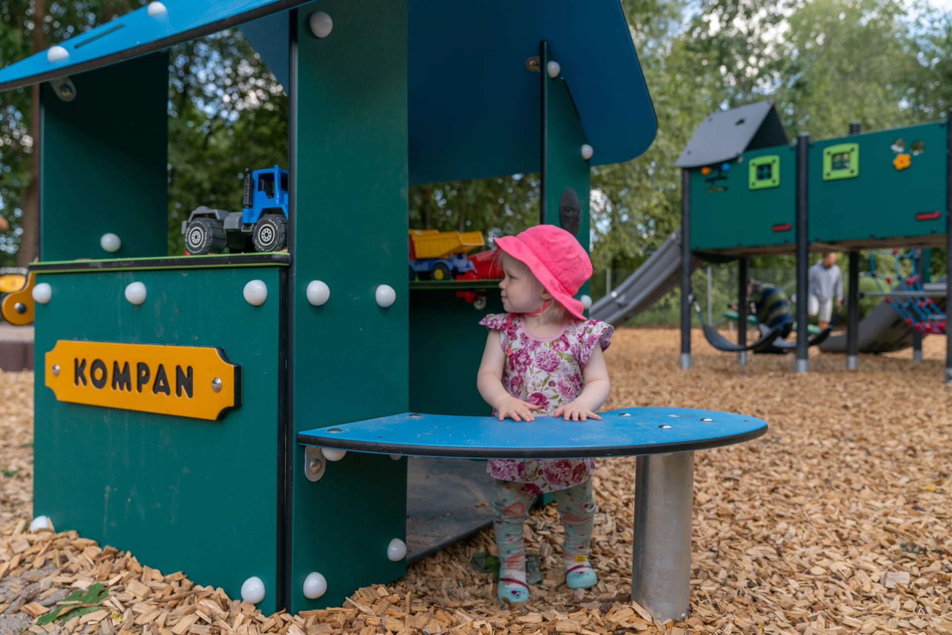 toddler playing on KOMPAN commercial play houses in a GreenLine edition