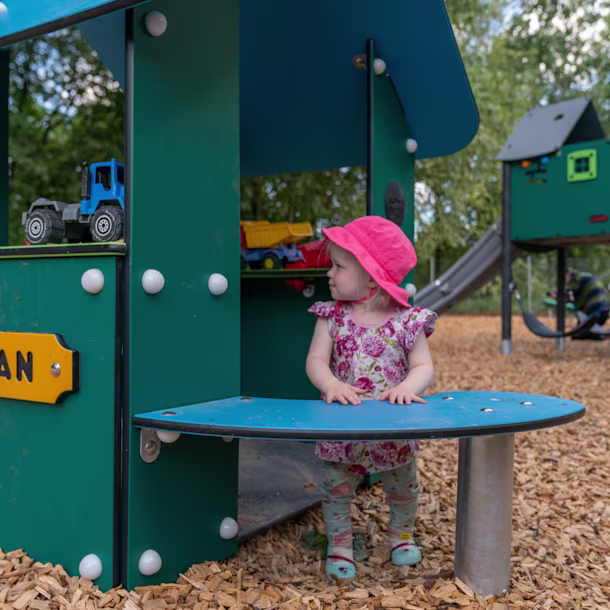toddler playing on KOMPAN commercial play houses in a GreenLine edition
