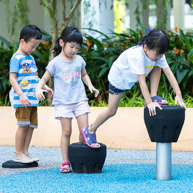 children playing on playground equipment that trains balance