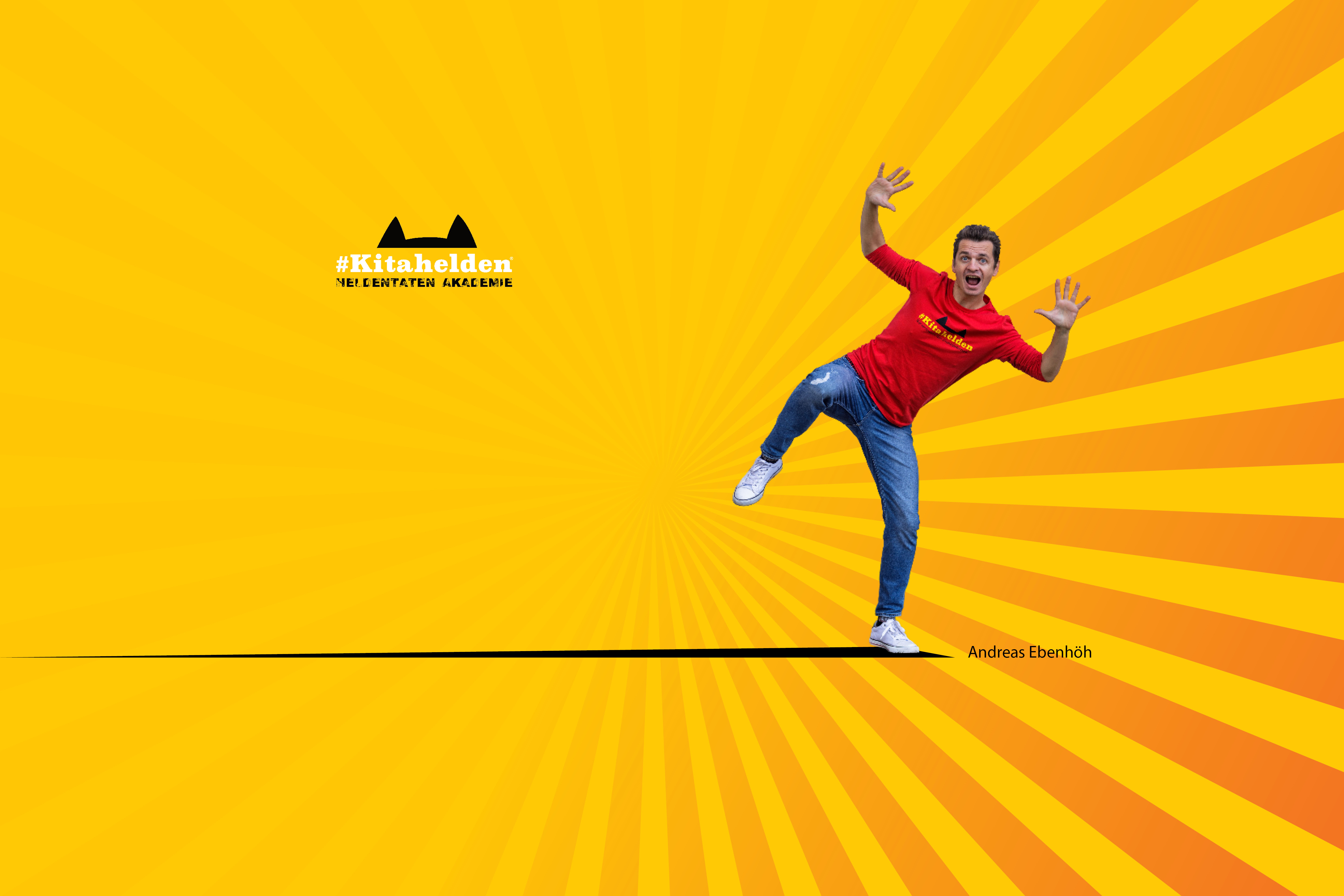 Person in red #Kitahelden shirt posing playfully on bright yellow sunburst background with black logo and name Andreas Ebenhöh