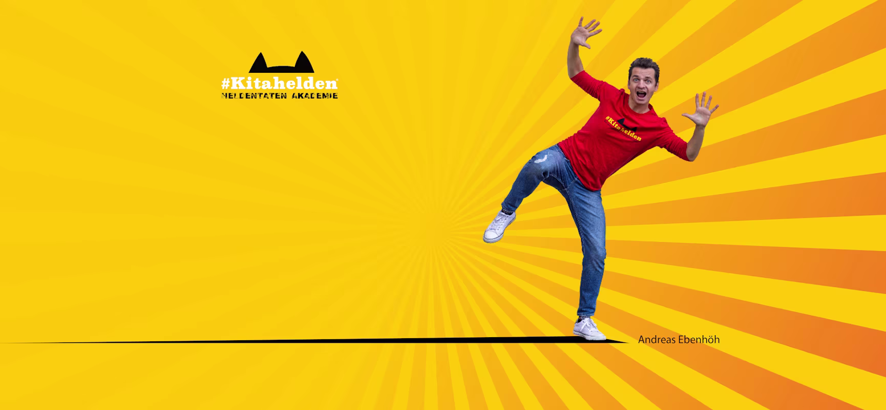 Person in red #Kitahelden shirt posing playfully on bright yellow sunburst background with black logo and name Andreas Ebenhöh