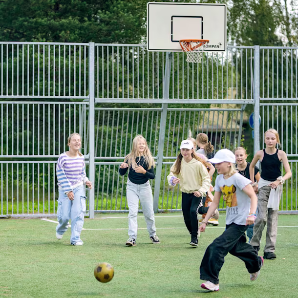 Kids playing soccer in an outdoor multisport arena