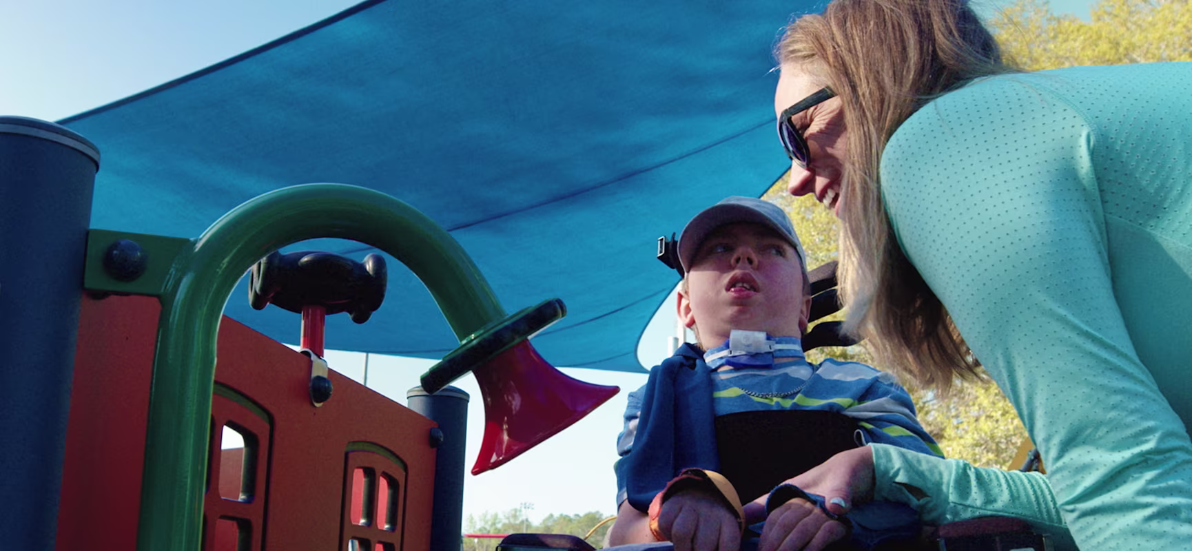 Advocacy Abby and two children at inclusive playground