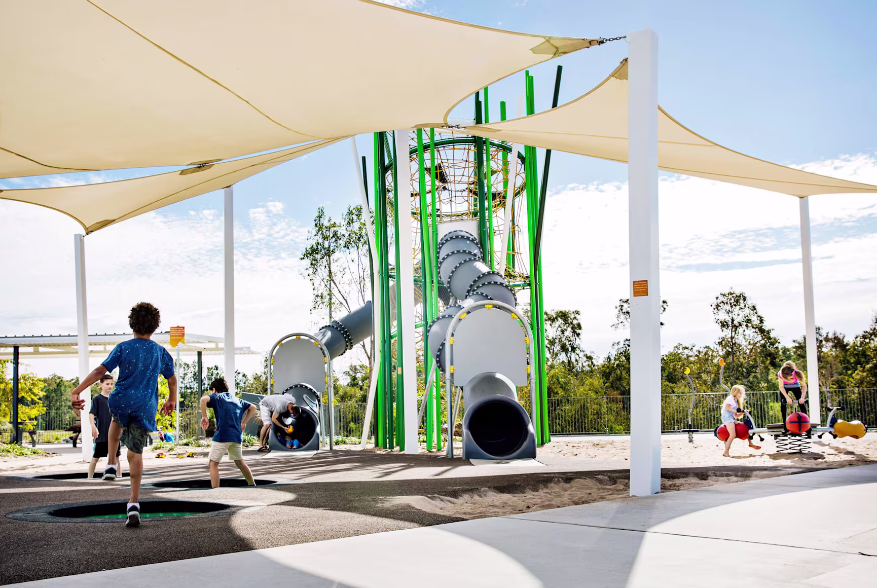 playground products - children playing on a large metal castle themed playground