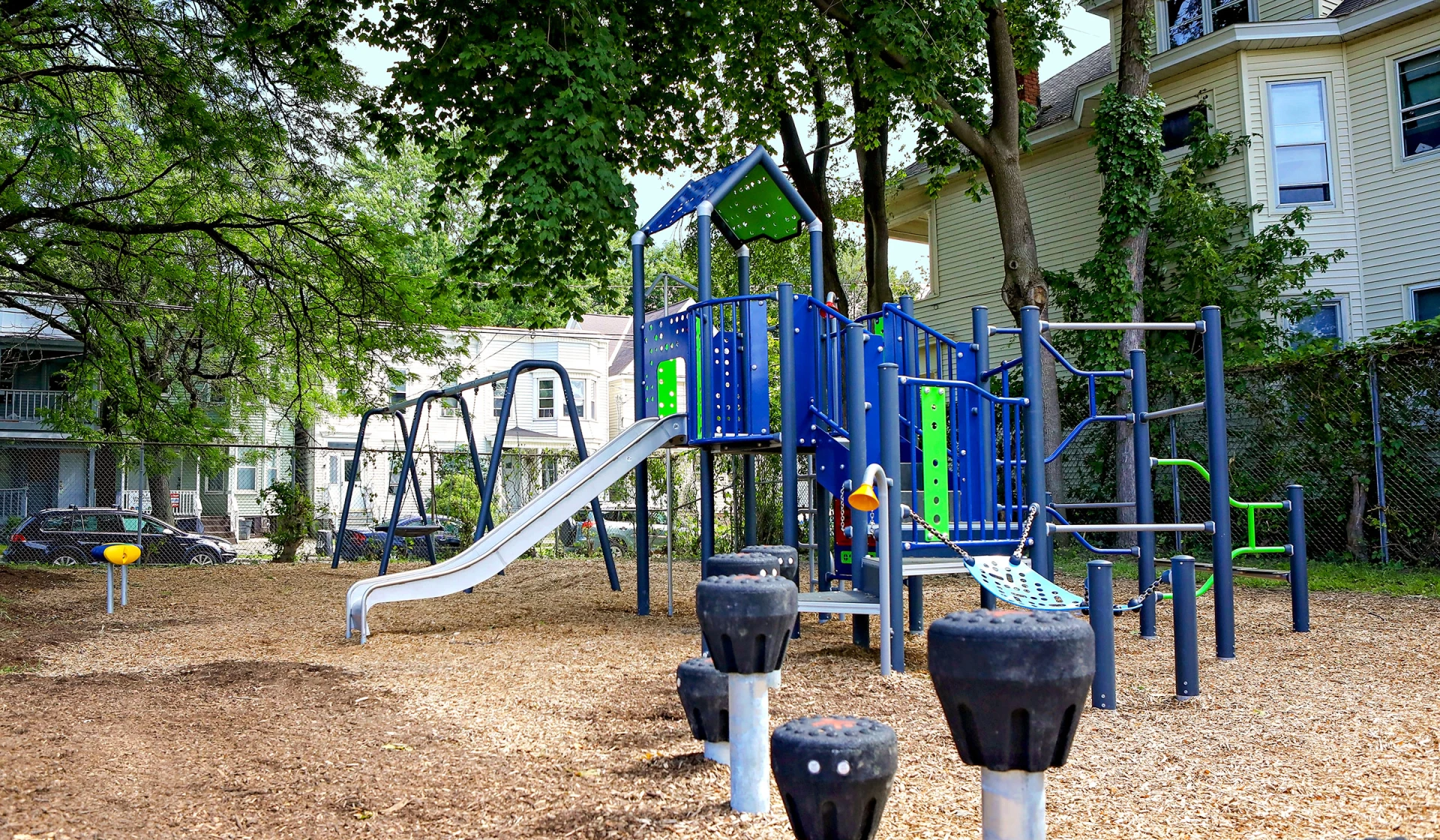 Children having fun sliding and climbing on a MOMENT play system