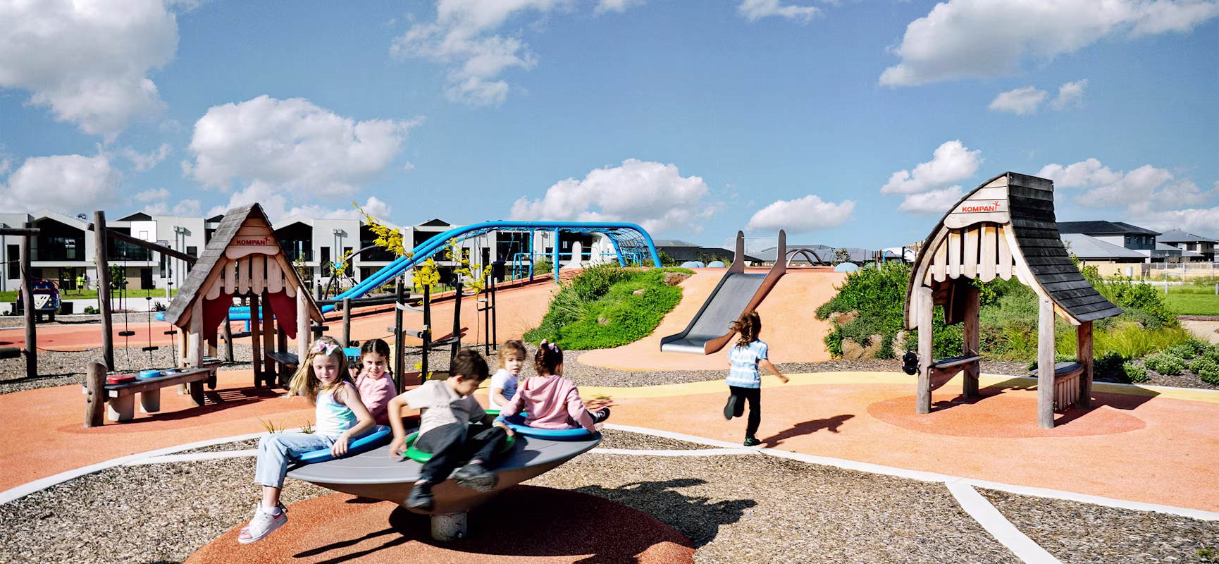 Multiple children playing on a KOMPAN playground in Australia