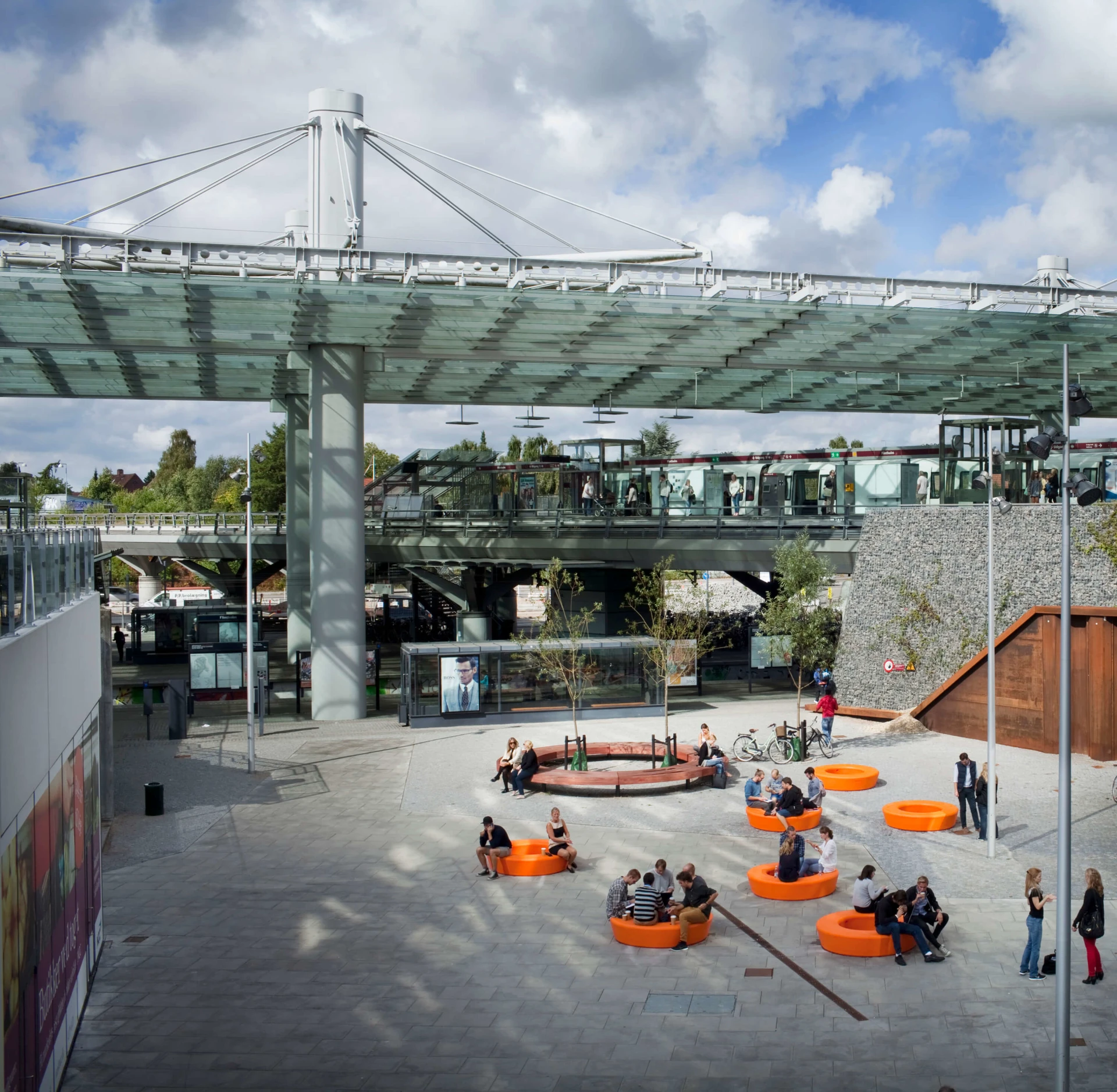 people sitting on outdoor park furniture in a city centre