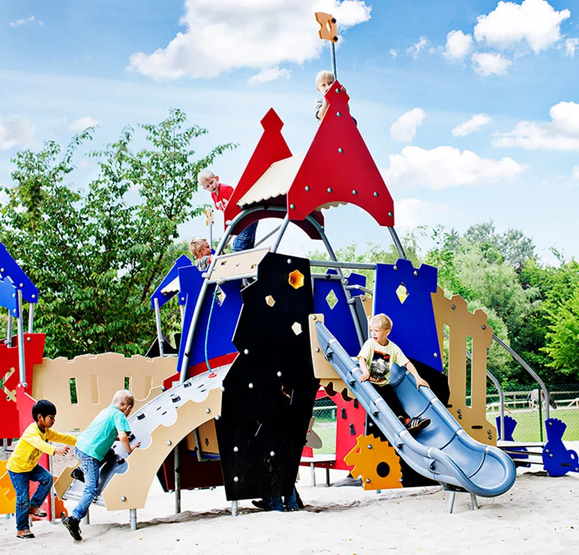 children climbing and sliding on colourful playground set