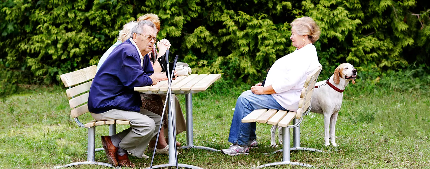 seniors relaxing on classic outdoor furniture at a park