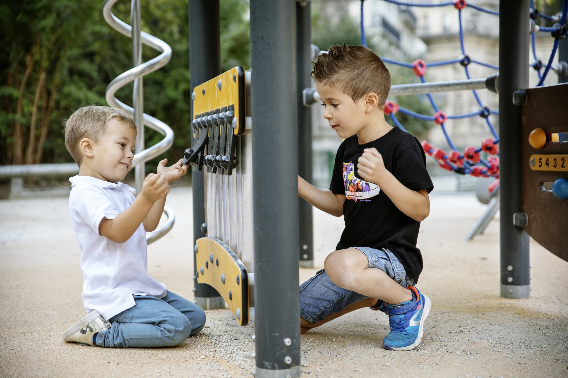 Children playing with music and sound playground equipment