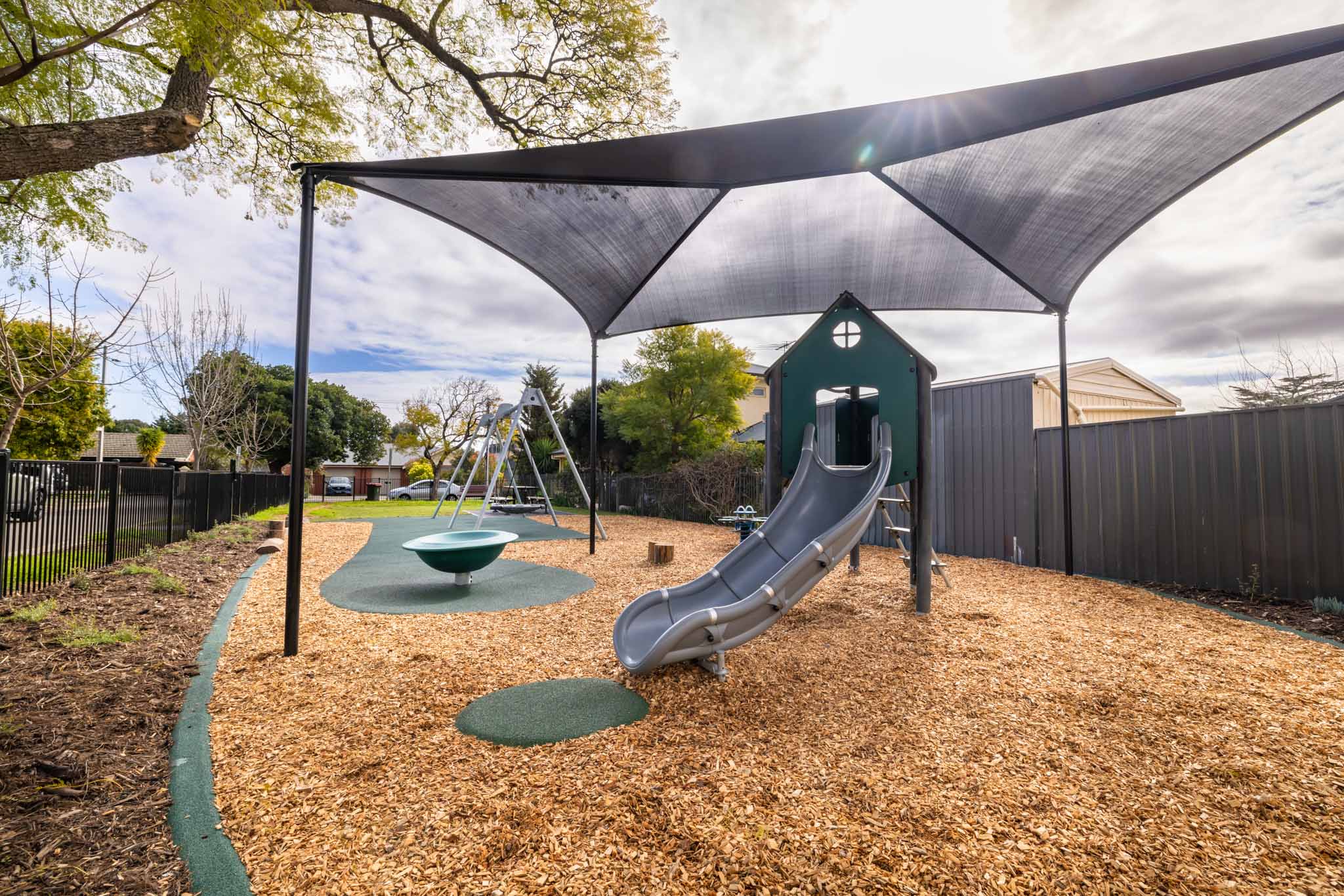 playground shade structure on a climbing playground structure