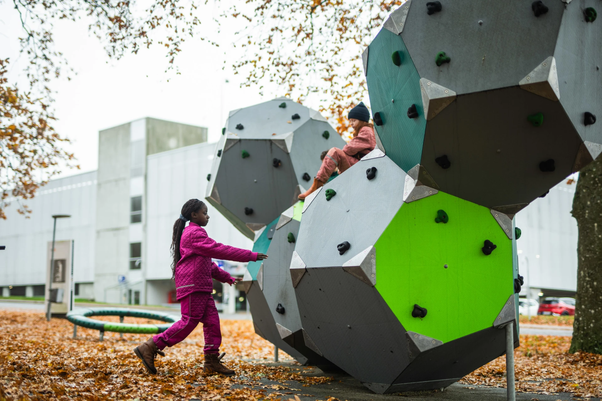 Girls playing on a large playground climbing structure