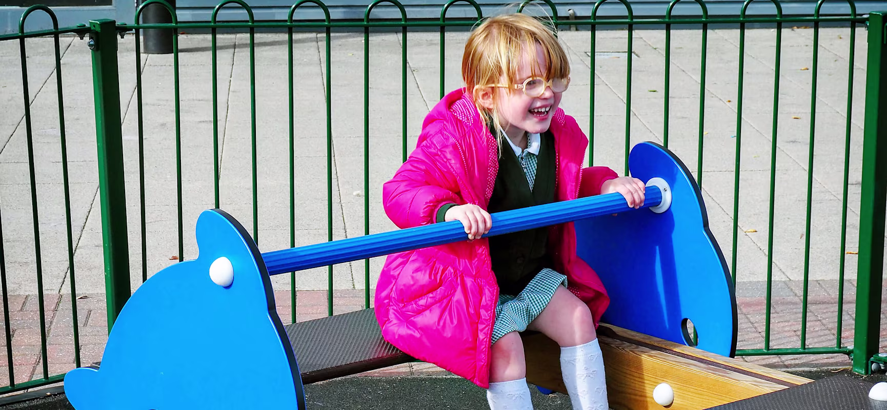 Girl on a dolphin seesaw at Xscape entertainment center in Yorkshire
