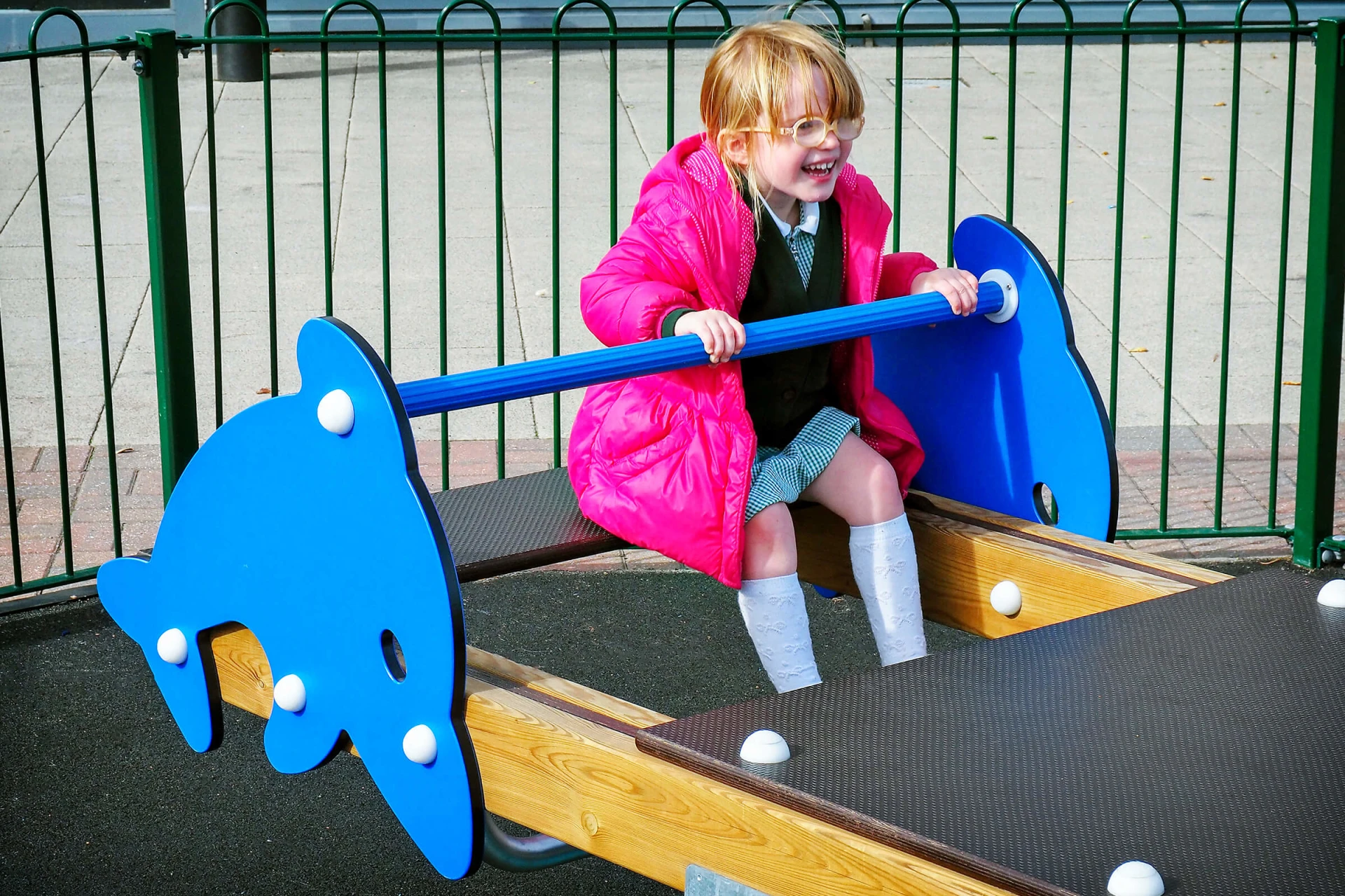 Girl on a dolphin seesaw at Xscape entertainment center in Yorkshire