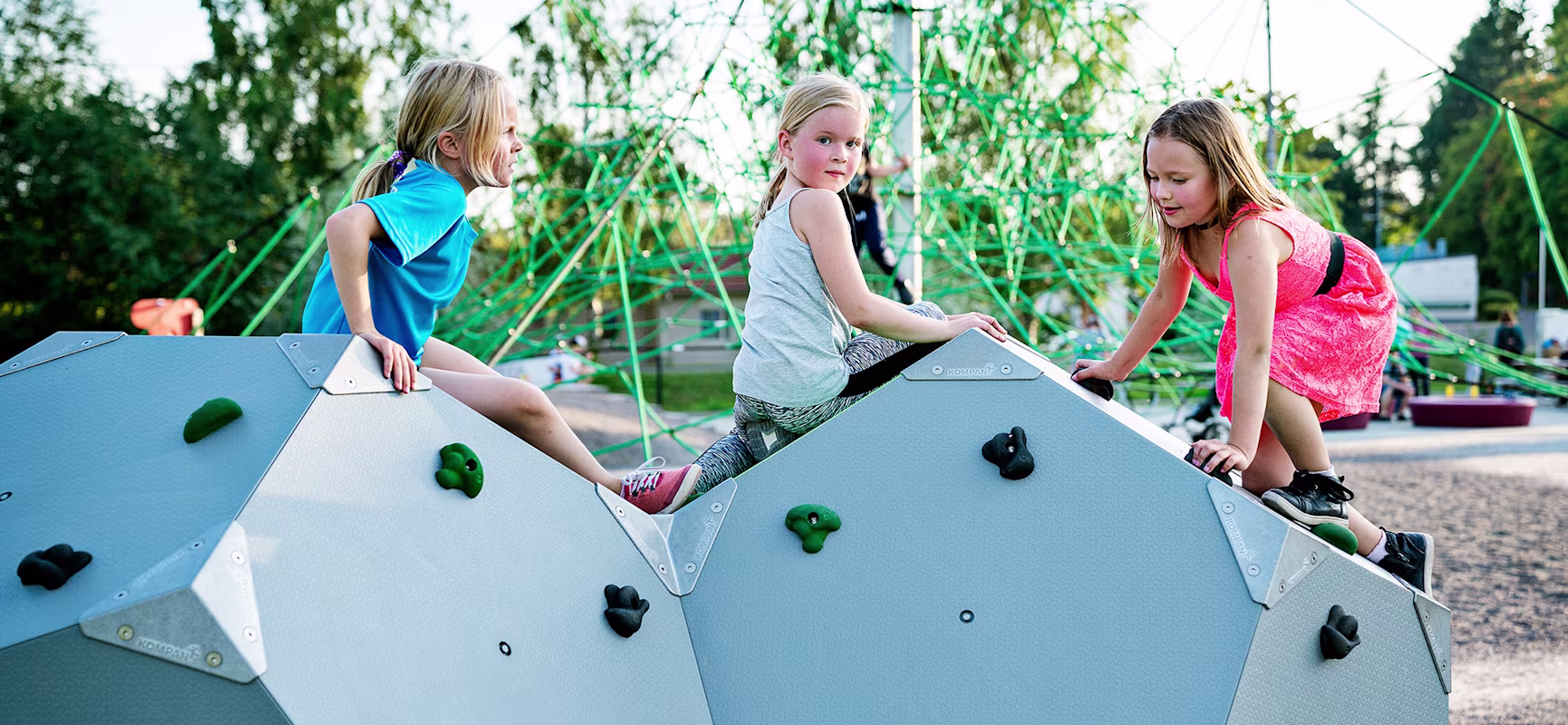 Three girls climbing on climbing blocks at Joroinen park in Finland
