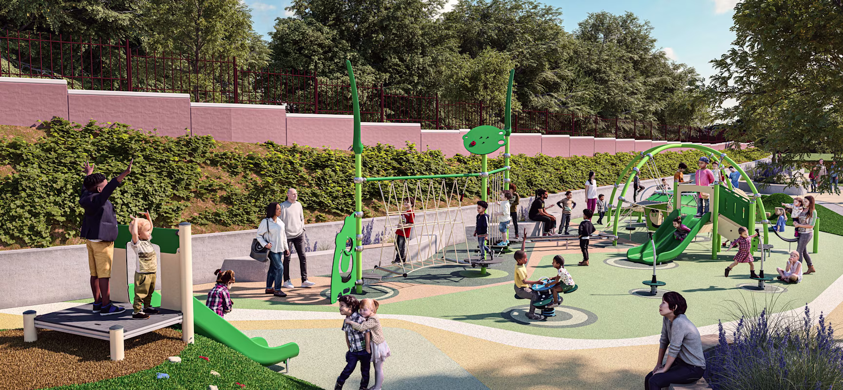 Children and adults play on a busy green playground with slides, climbers and swings, surrounded by trees and a pink wall.