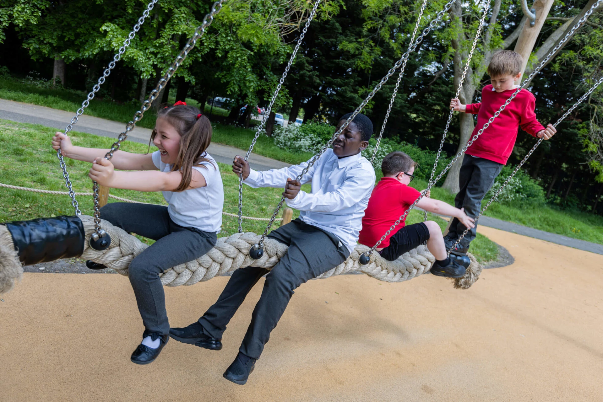 children playing on special education needs playground equipment