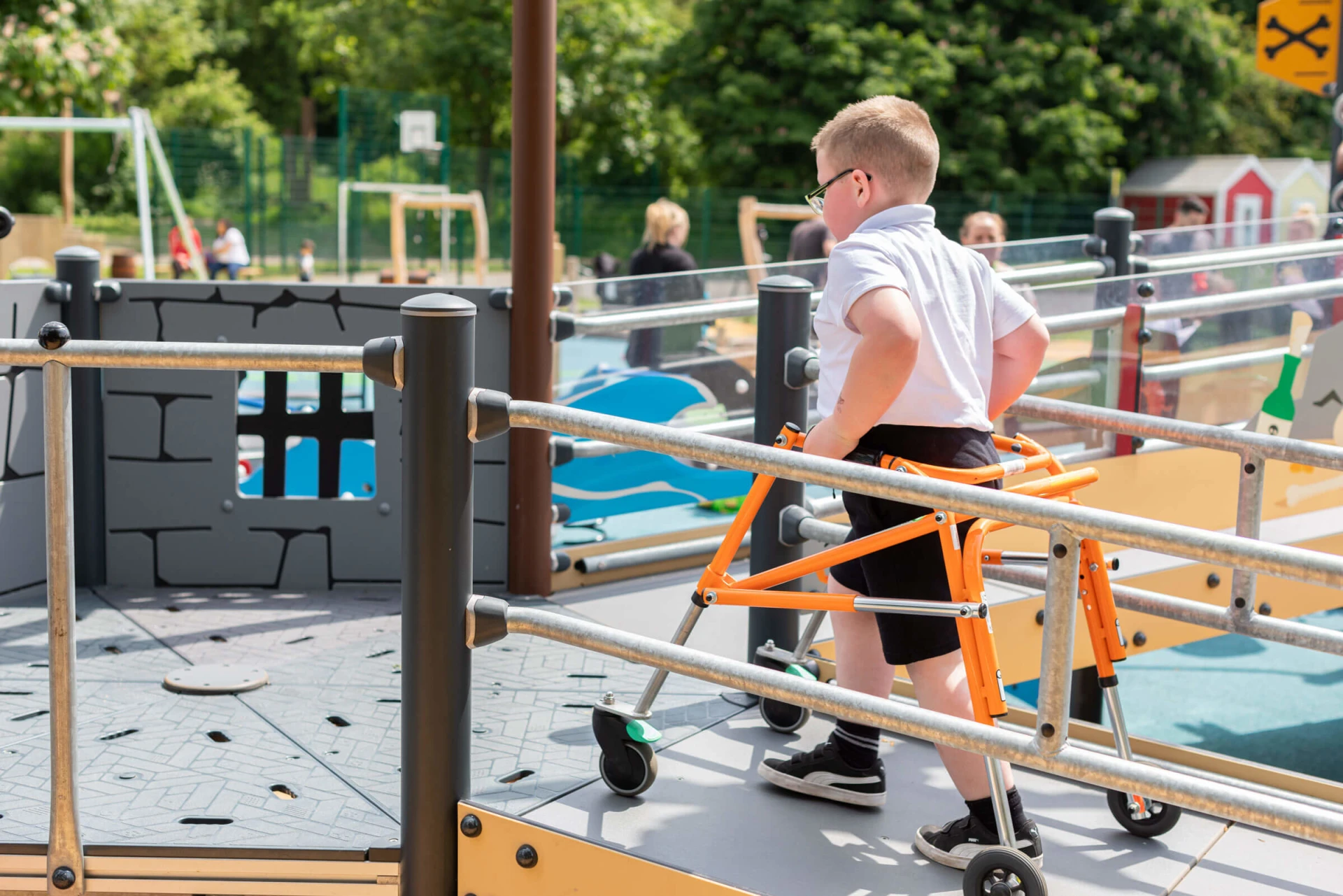 children playing on special education needs playground equipment