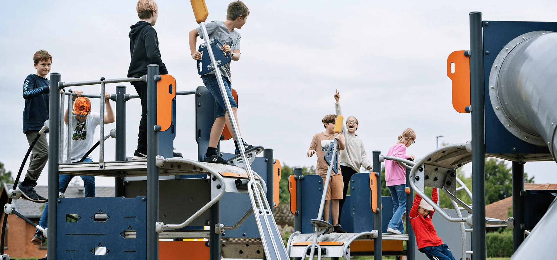 hero image of children playing on playground system for school-agers 