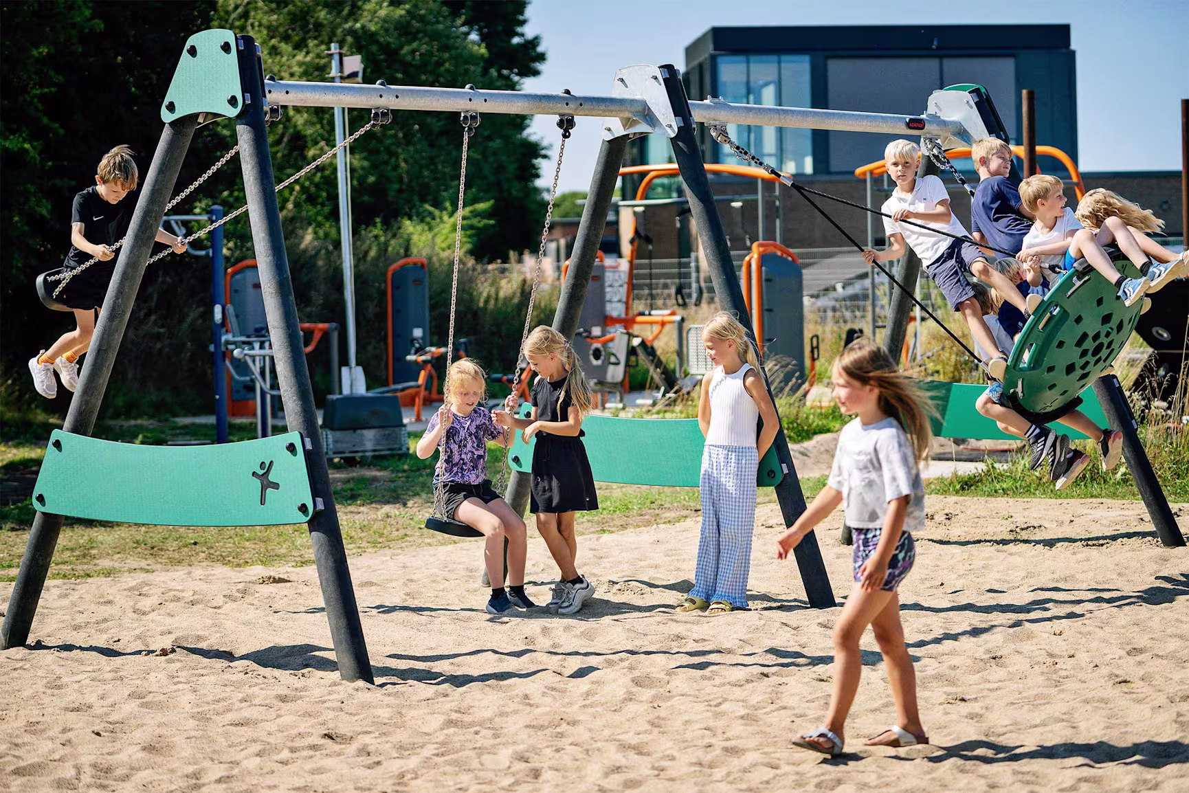 Children playing on a sustainably conscious swing set