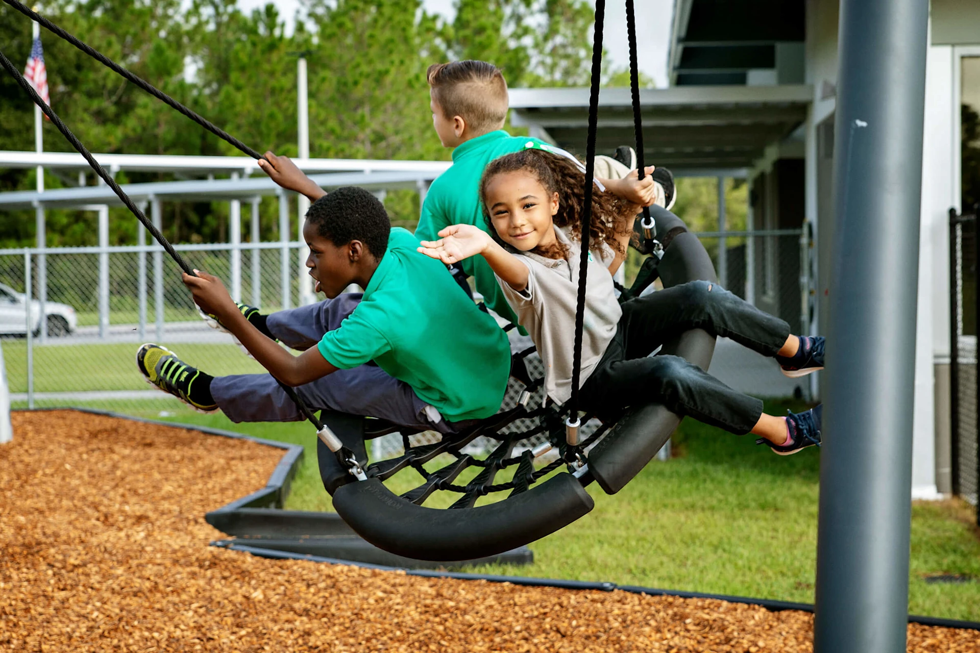 Pupils playground on a swing in their school yard 