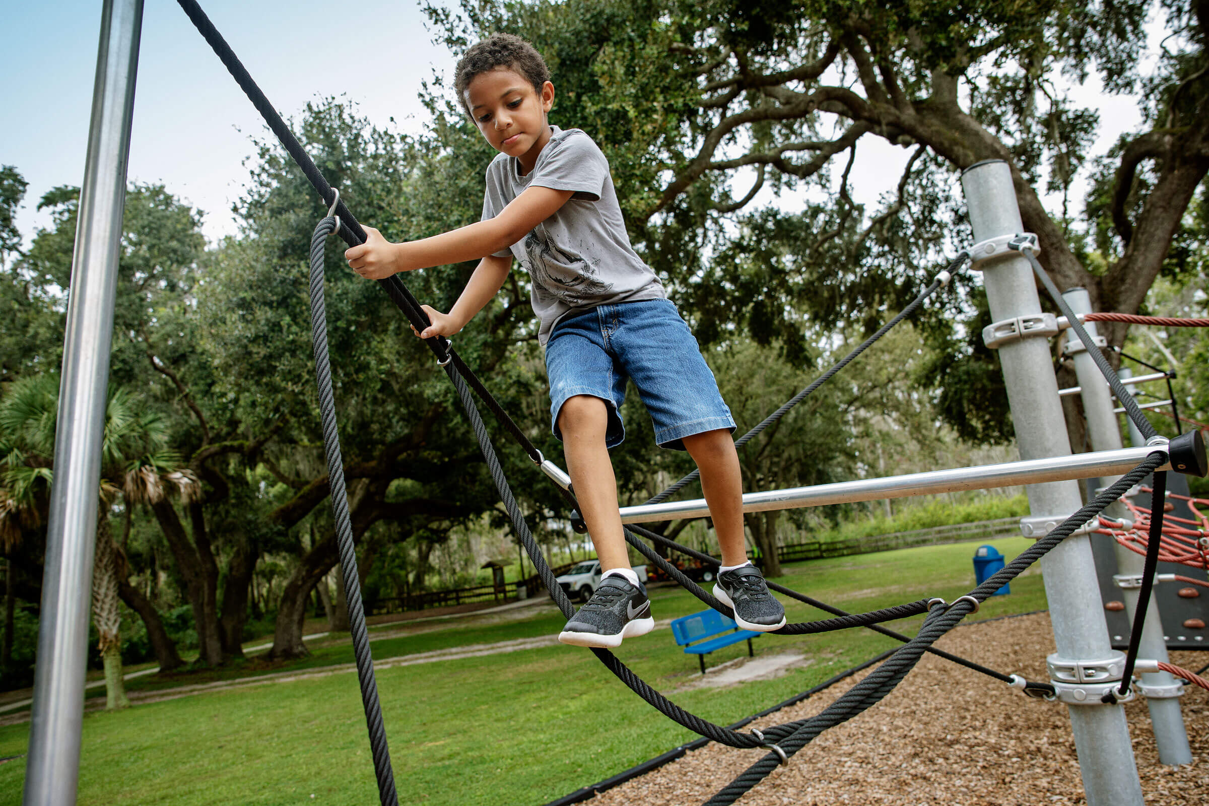boy balancing on climbing trail at Palatlakaha Park