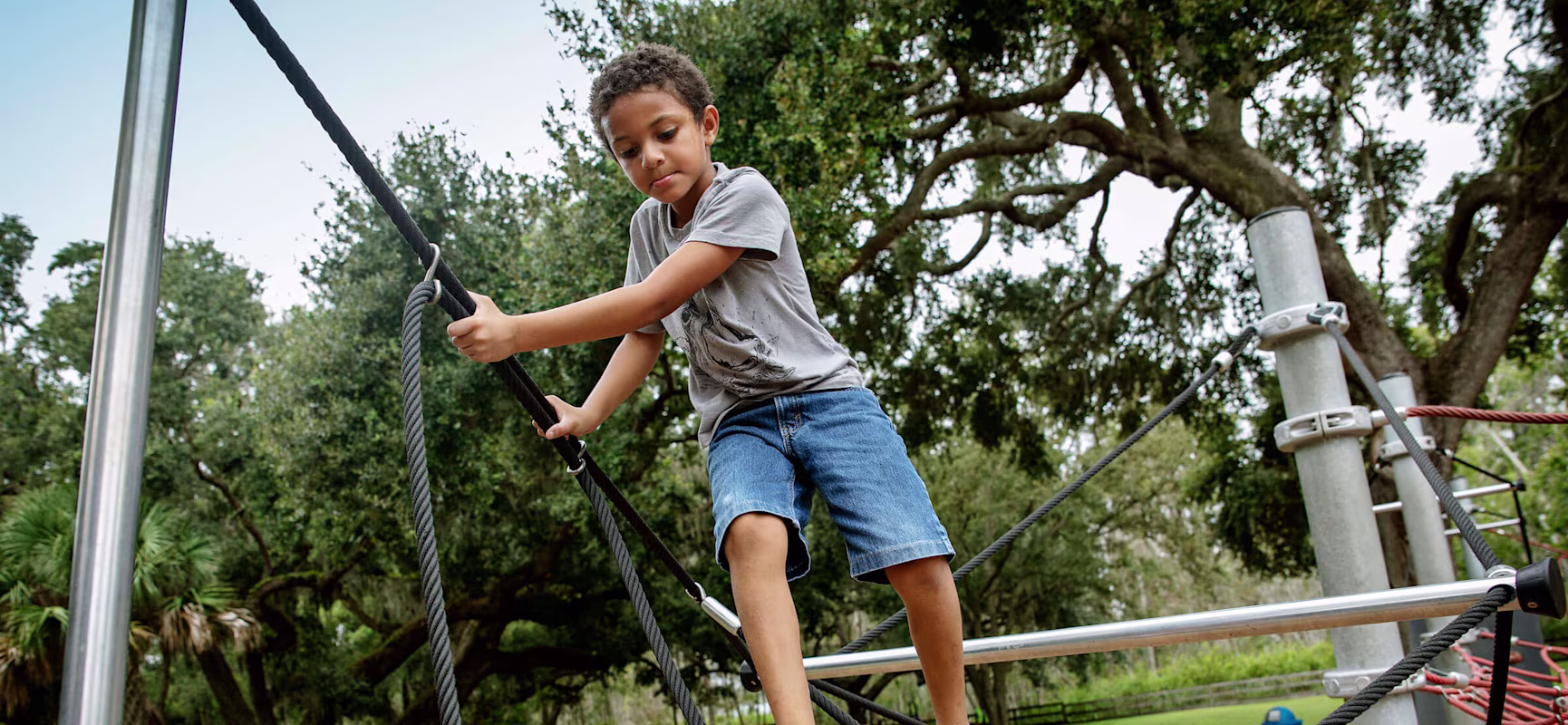 boy balancing on climbing trail at Palatlakaha Park