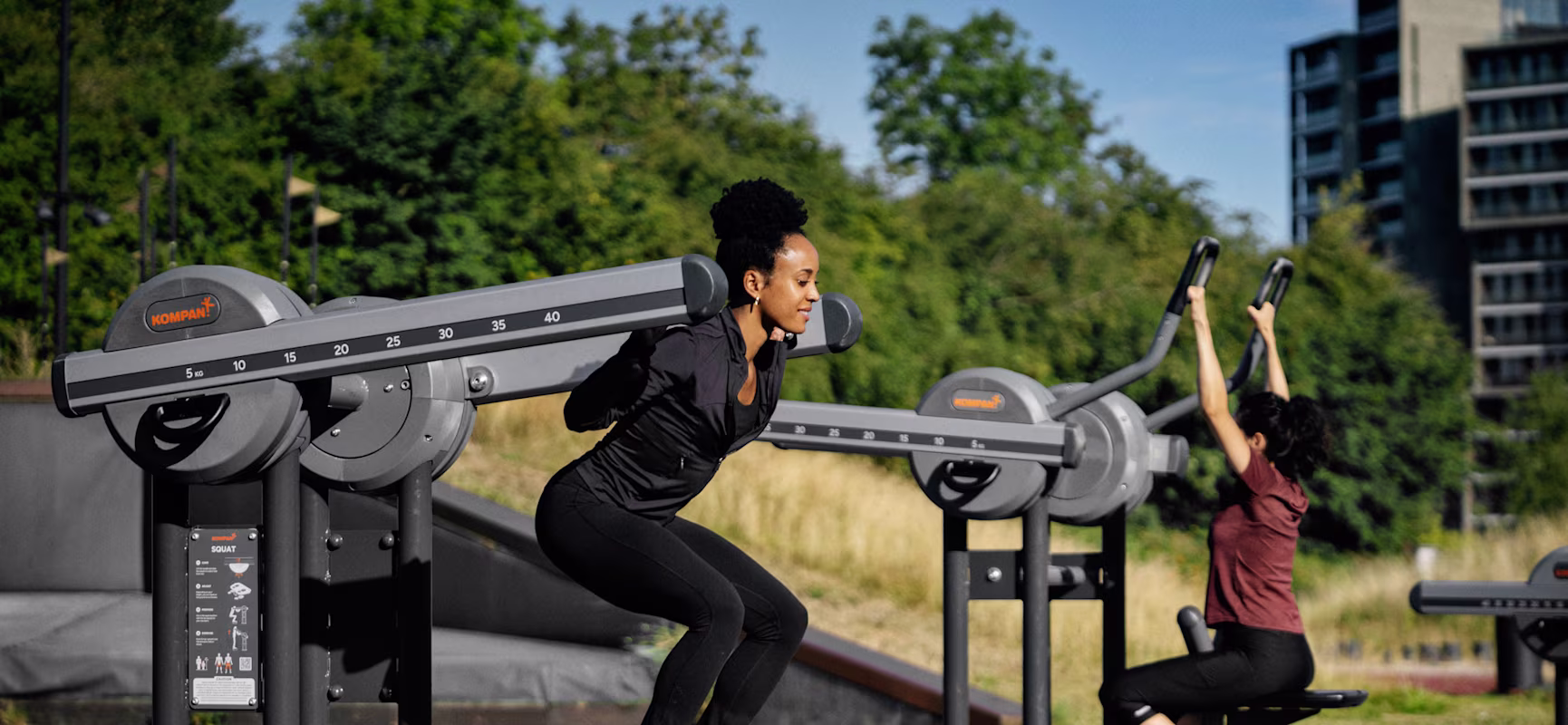 Man and woman working out on an outdoor gym