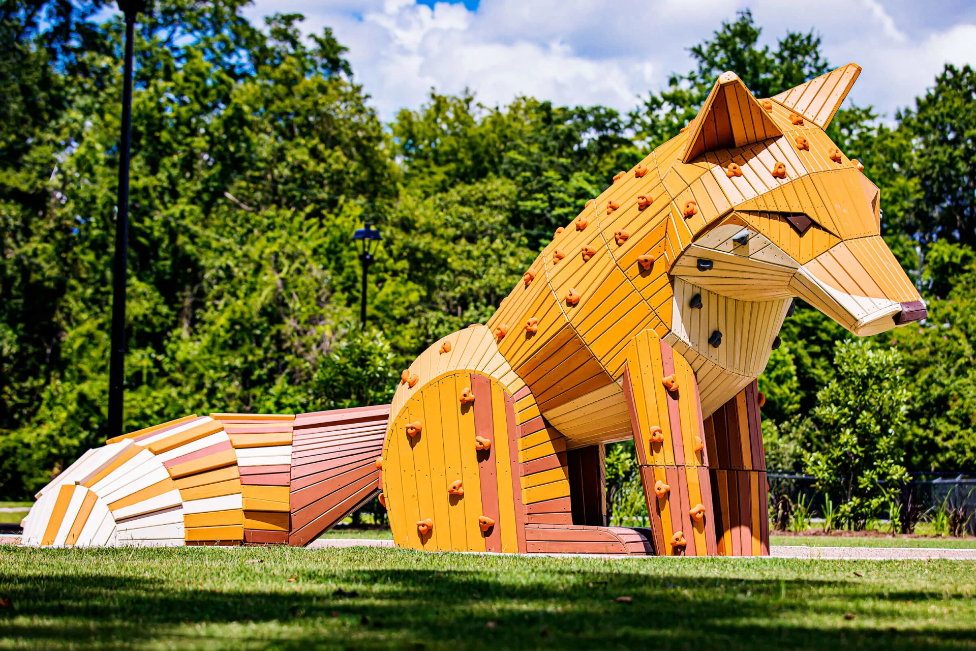 Wooden play sculpture at Amazing Grace Park looking like a fox