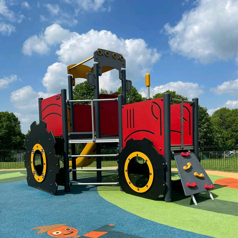 Tractor themed playground structure in a park