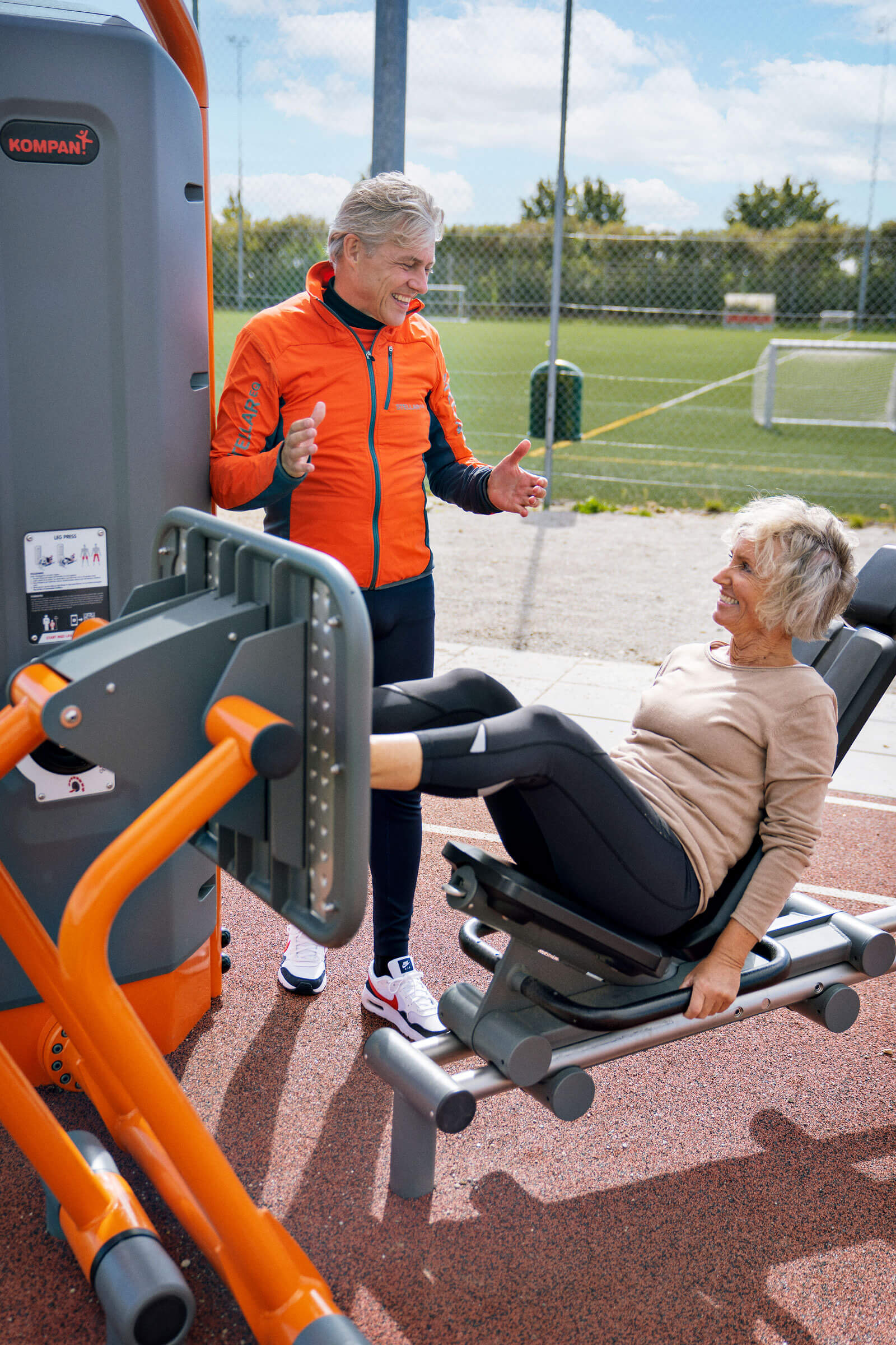 seniors using an outdoor leg press mashine