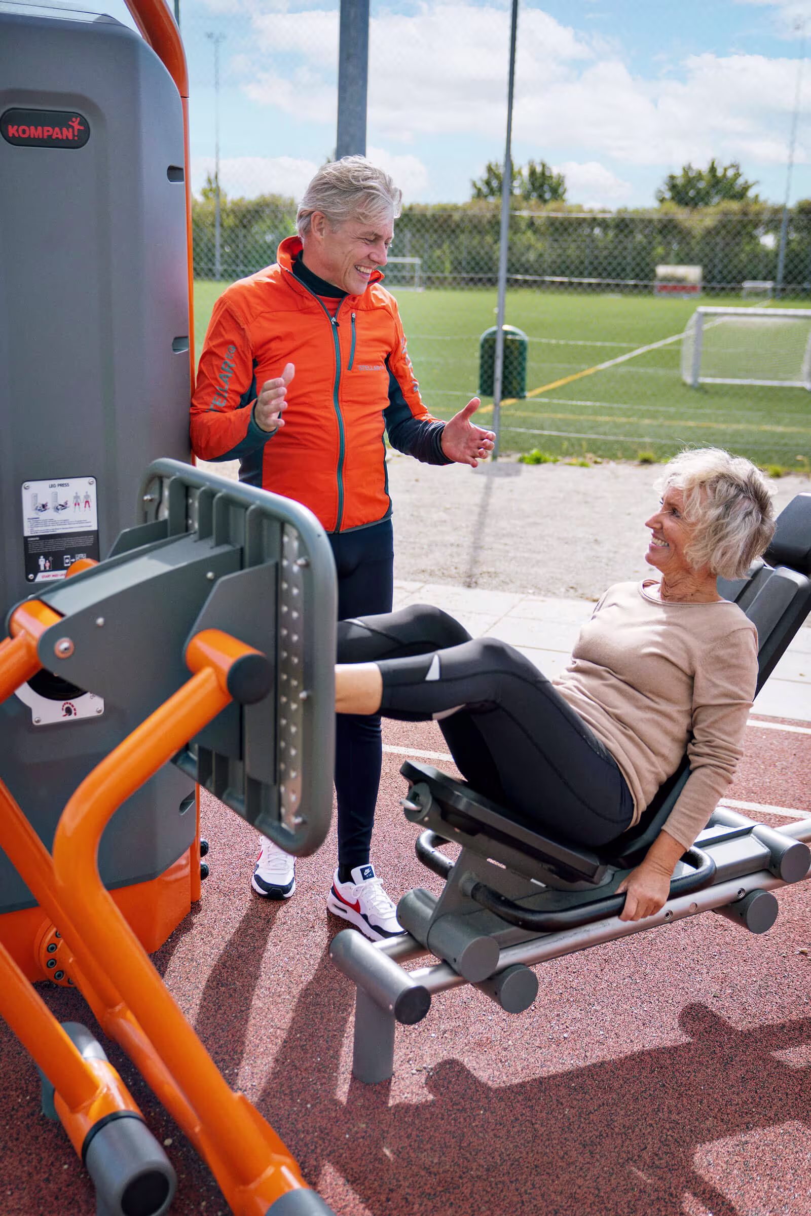 seniors using an outdoor leg press mashine