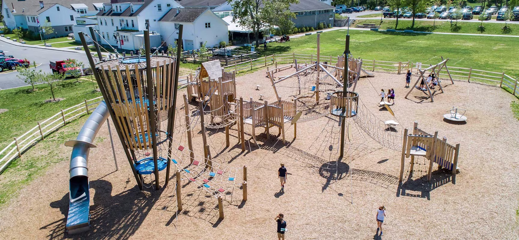 an aerial view of a wooden school playground with large play tower.