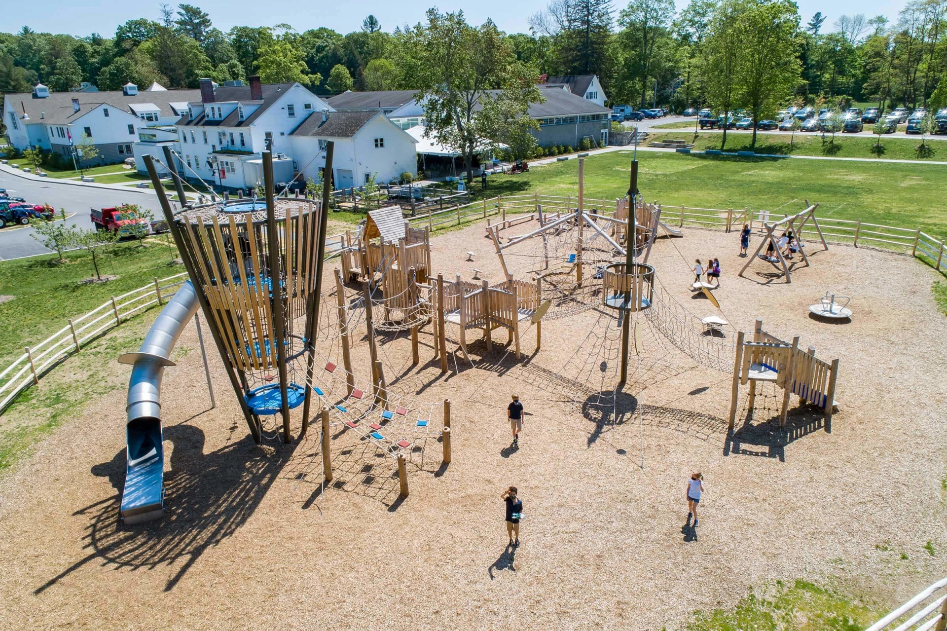 an aerial view of a wooden school playground with large play tower.